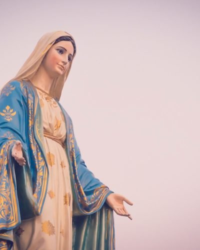 The blessed Virgin Mary statue figure in a sunset time. Catholic praying for our lady - The Virgin Mary.