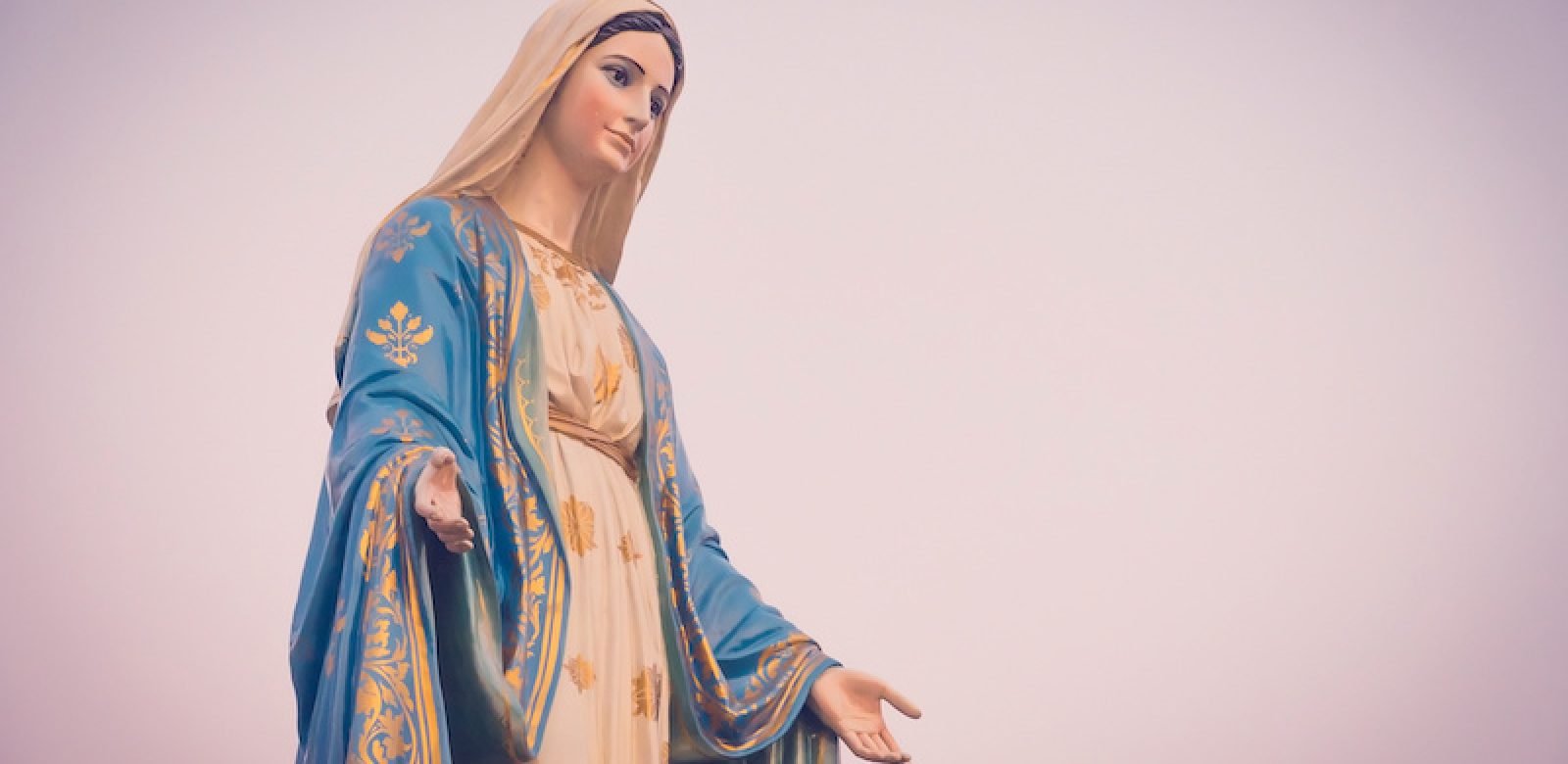 The blessed Virgin Mary statue figure in a sunset time. Catholic praying for our lady - The Virgin Mary.
