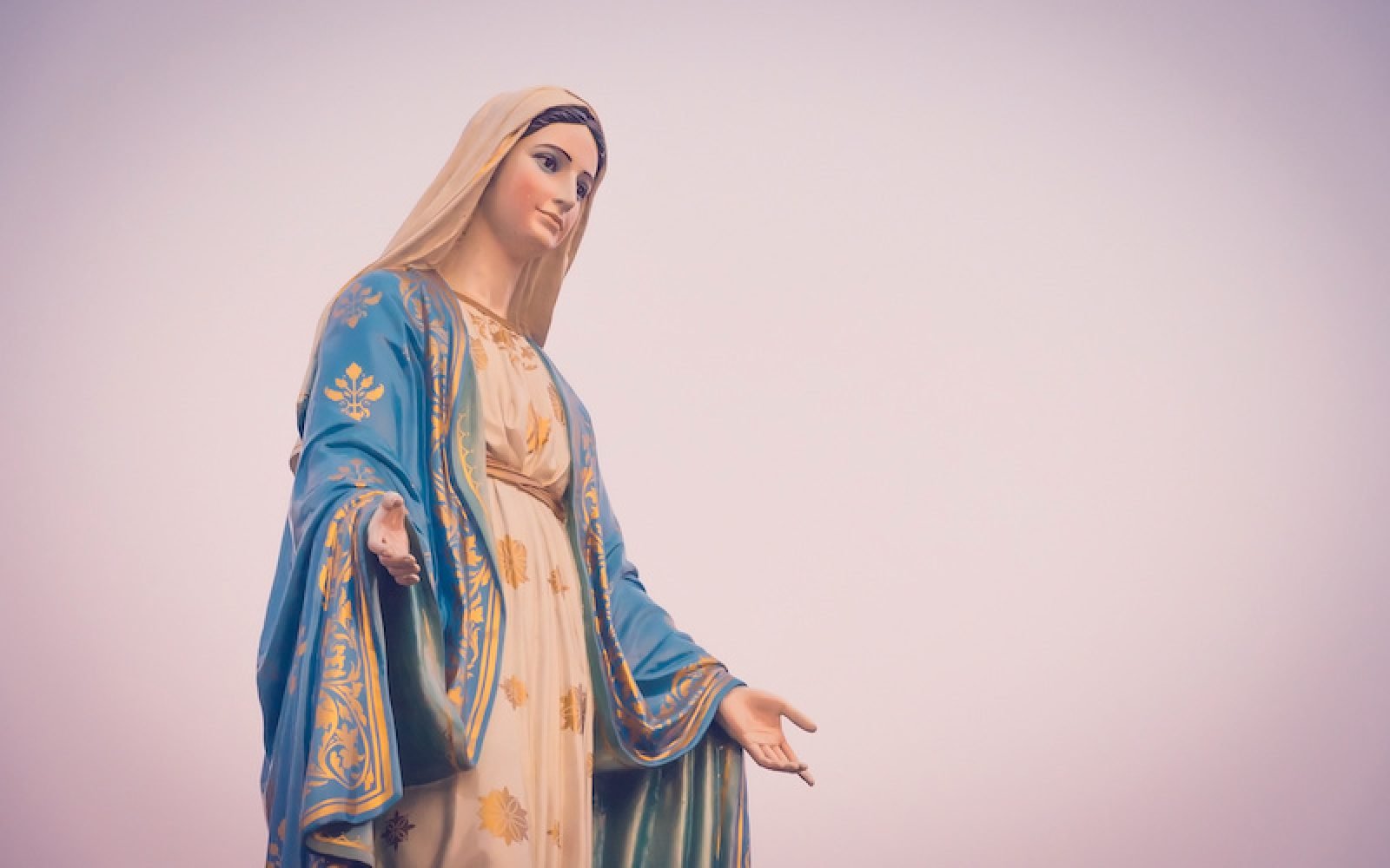 The blessed Virgin Mary statue figure in a sunset time. Catholic praying for our lady - The Virgin Mary.