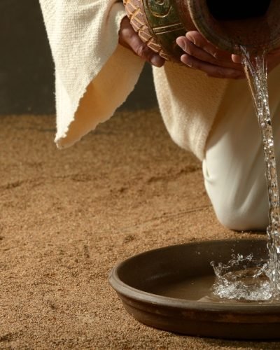 Jesus pouring water from a jug (with copyspace for text)
